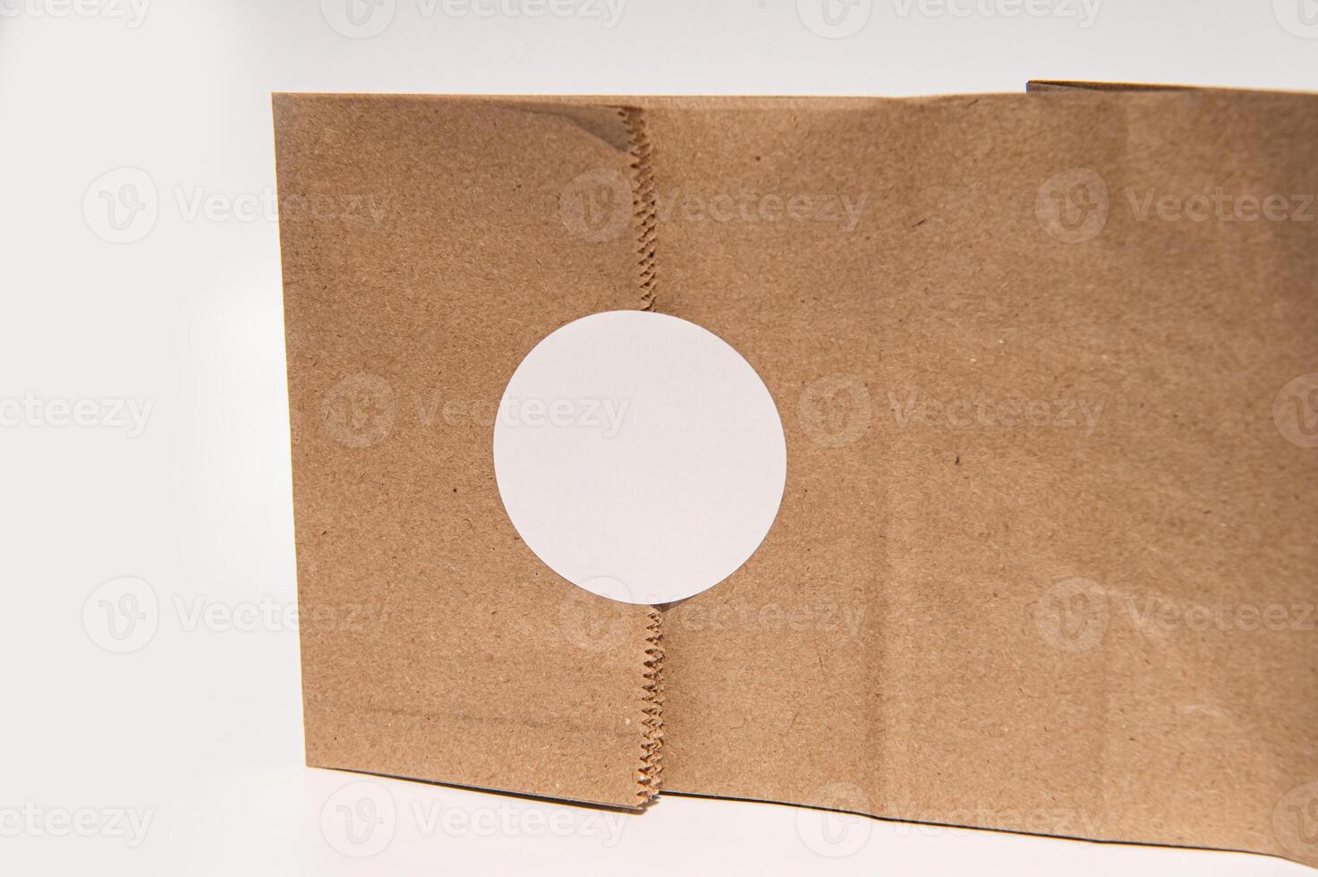 Cardboard box with circular cutout on white background photo