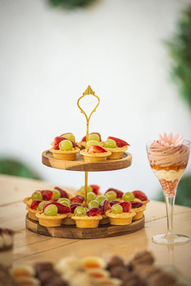 Fruit tarts on wooden stand photo