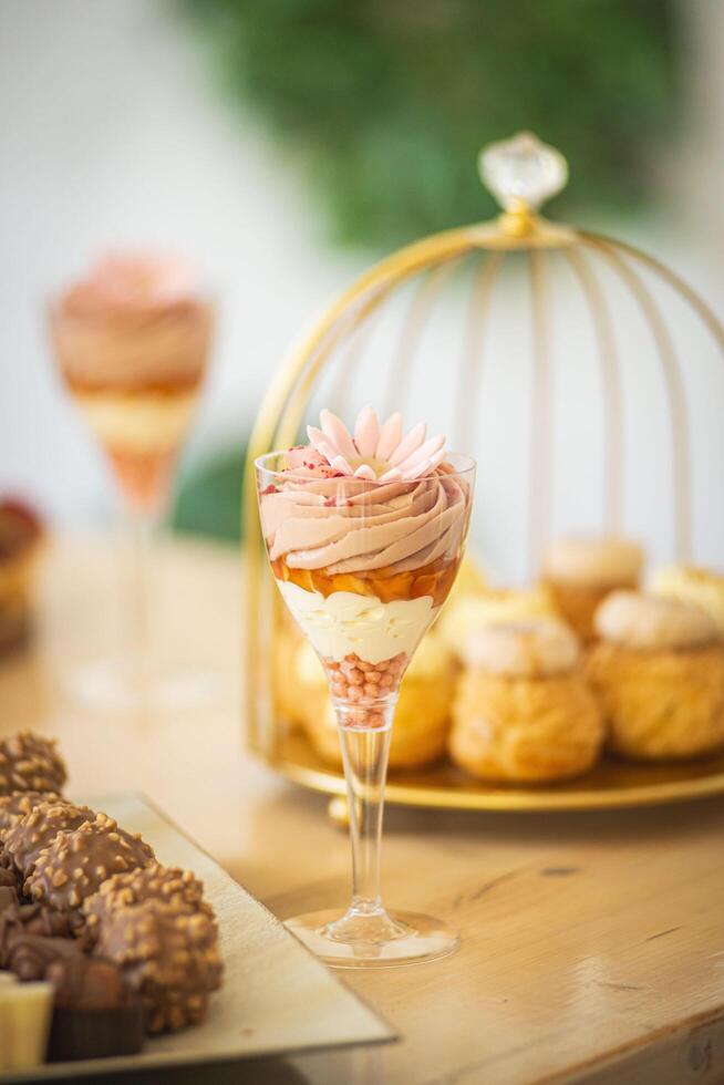 Colorful dessert in a glass with flowers photo
