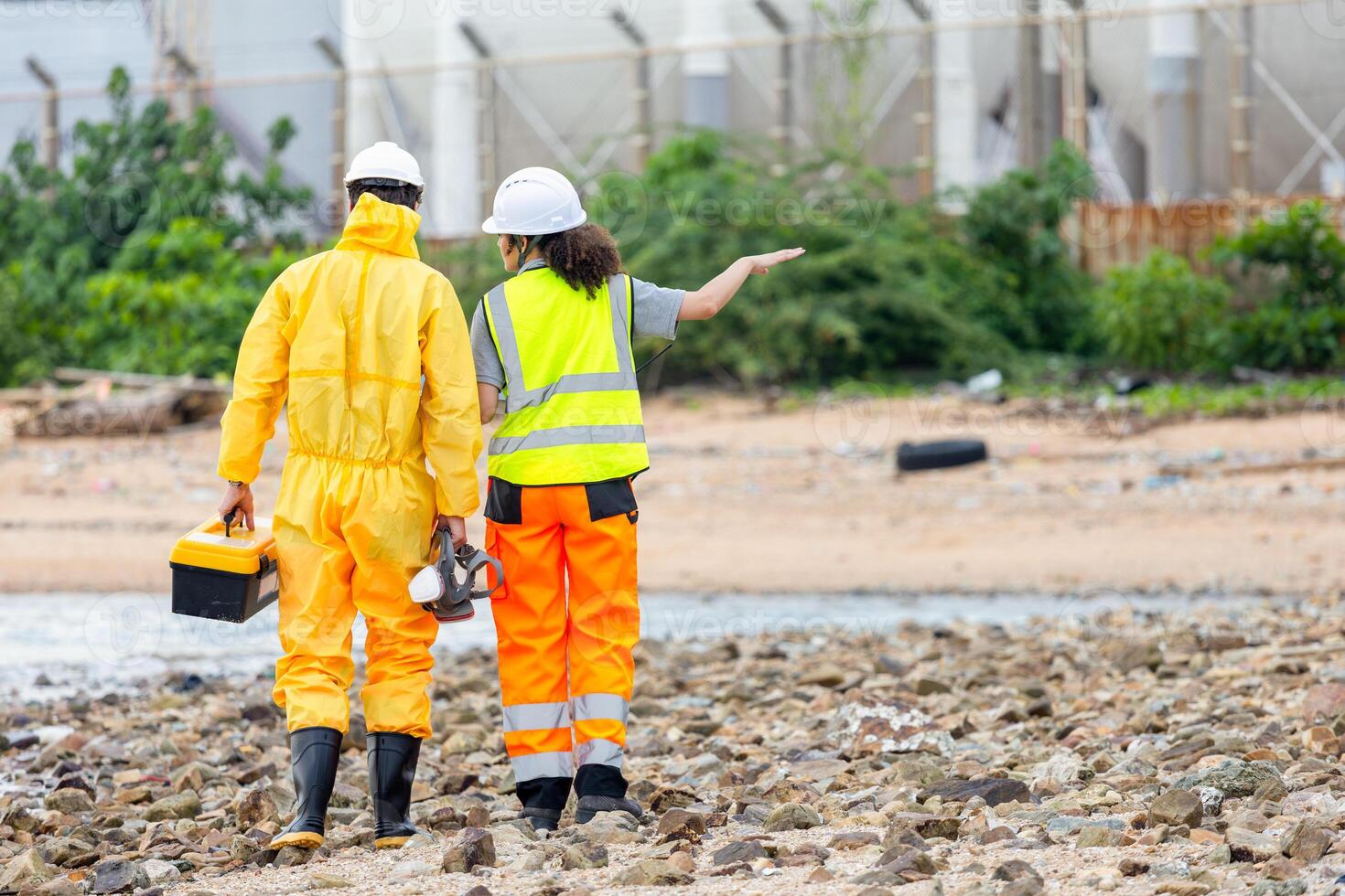 Back View of Researchers Testing Water Quality at a Lake or Coastal Area, Environmental Scientists Collecting Water Samples for Analysis, Water Pollution Control, Scientists at Work in the Field photo