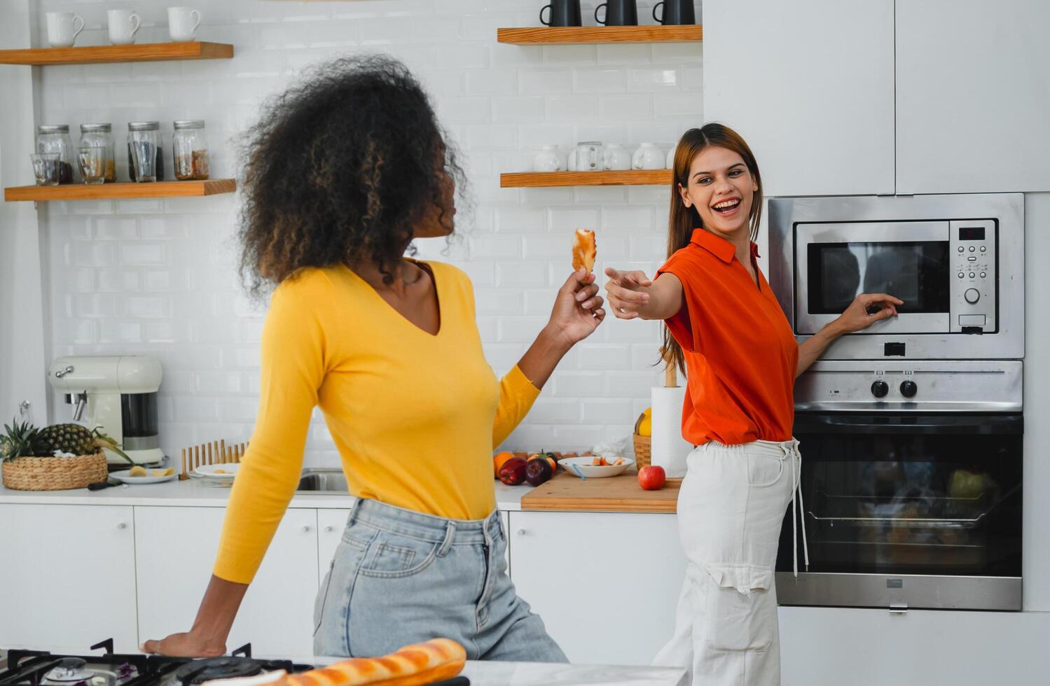 Friends enjoying cooking in the kitchen photo