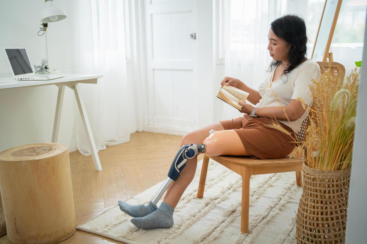 Woman with prosthetic leg reading a book photo