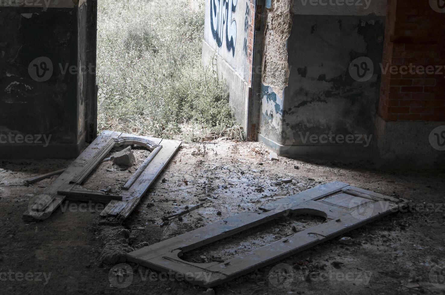 Details of fallen doors in house in ruins photo