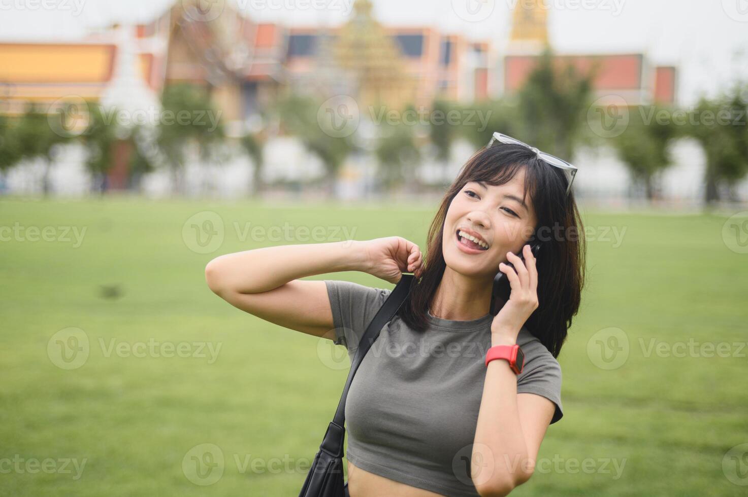 Happy southeast asian woman teenager blogger on solo world travel explorer tourism in Bangkok, Thailand. concept for local cultural experience in Asia, using smartphone to take photo