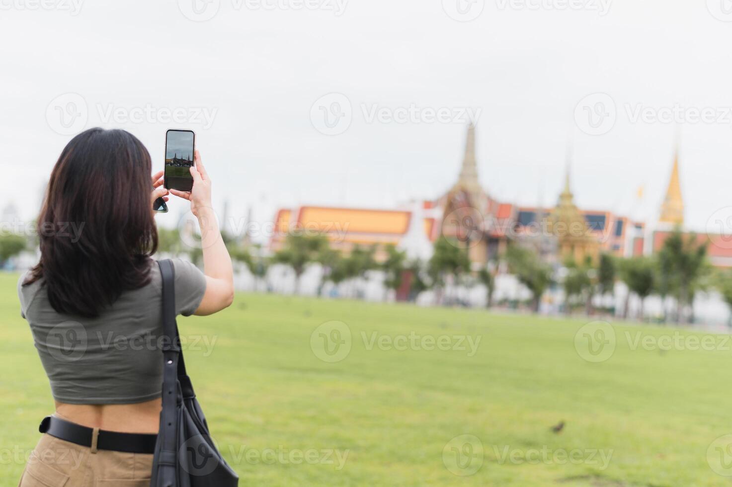 Solo southeast asian woman teenager and blogger world travel explorer take smartphone photo tourism concept for local cultural experience in Bangkok Thailand asia