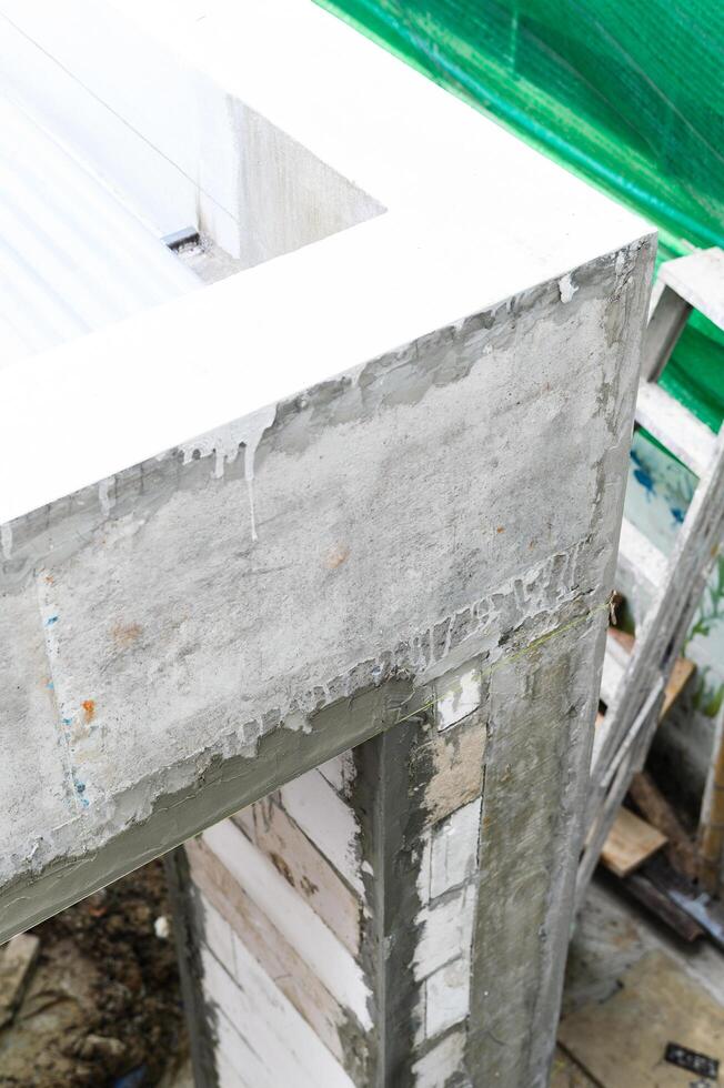 Closeup detail of rough concrete beam during major house renovation project. building construction shows raw architecture and strong cement work for new home photo