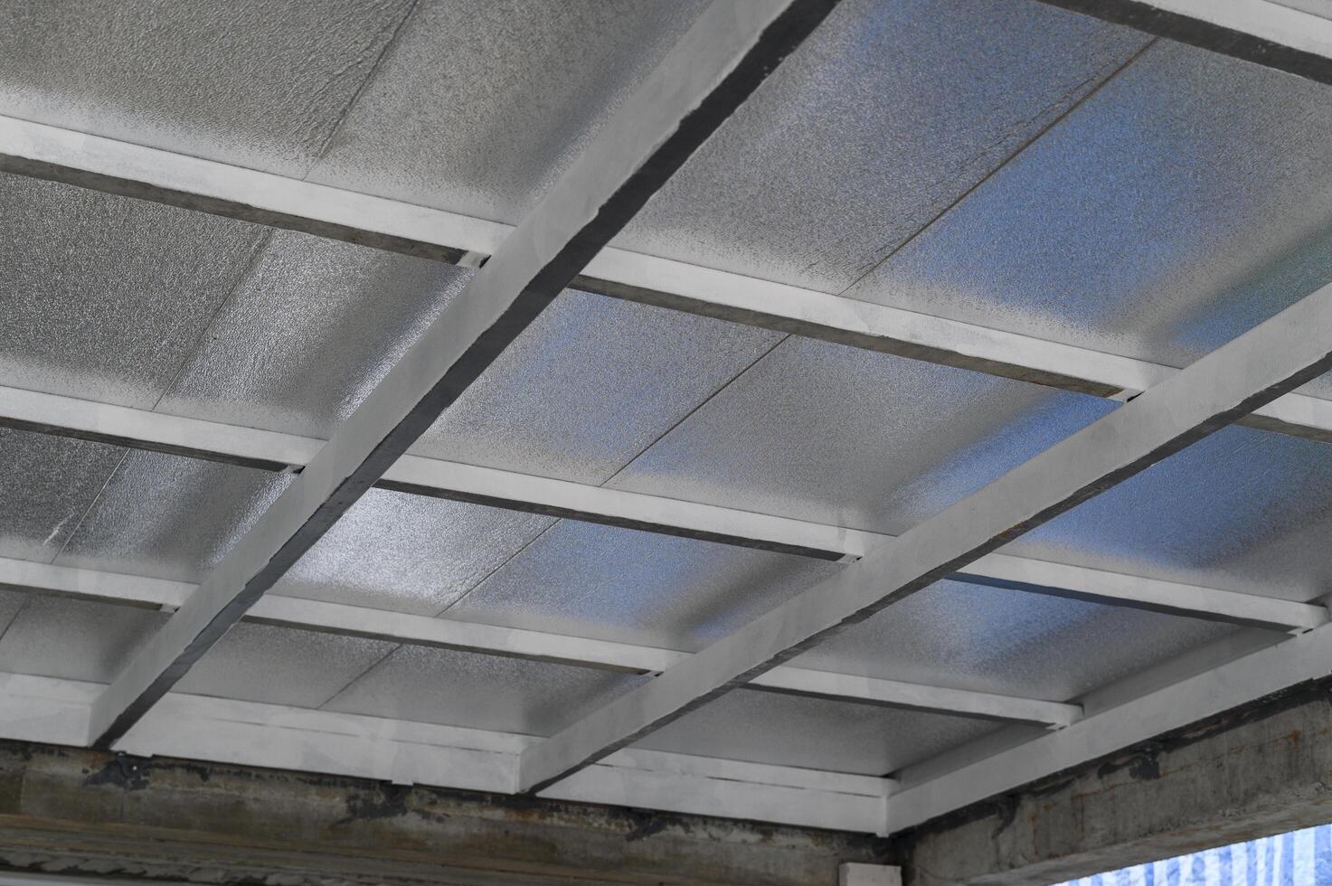 Installing building material ceiling structure featuring lightweight insulation panels using metal sheet outer layers and pu foam core for energy efficiency construction process photo