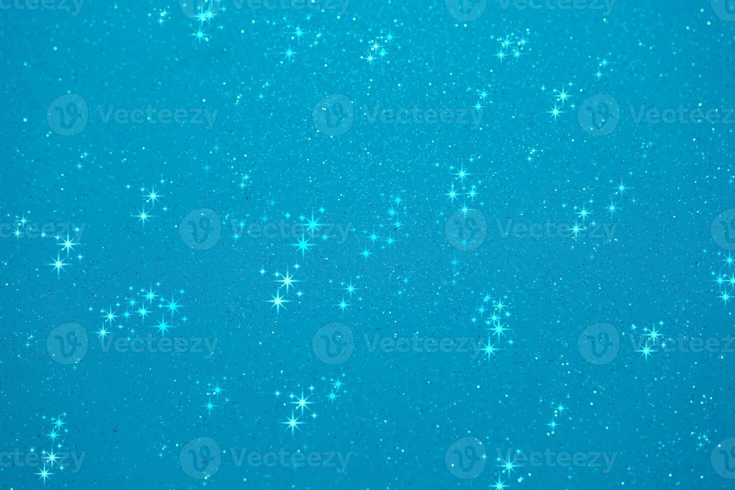 Glittering blue background filled with shining stars creates a dreamy and enchanting atmosphere suitable for various projects photo