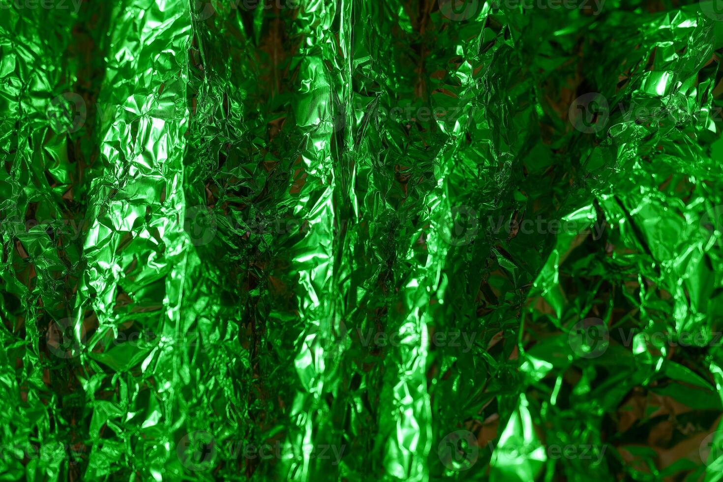 Shimmering green metallic foil texture creates dynamic visual effects in a close up view photo