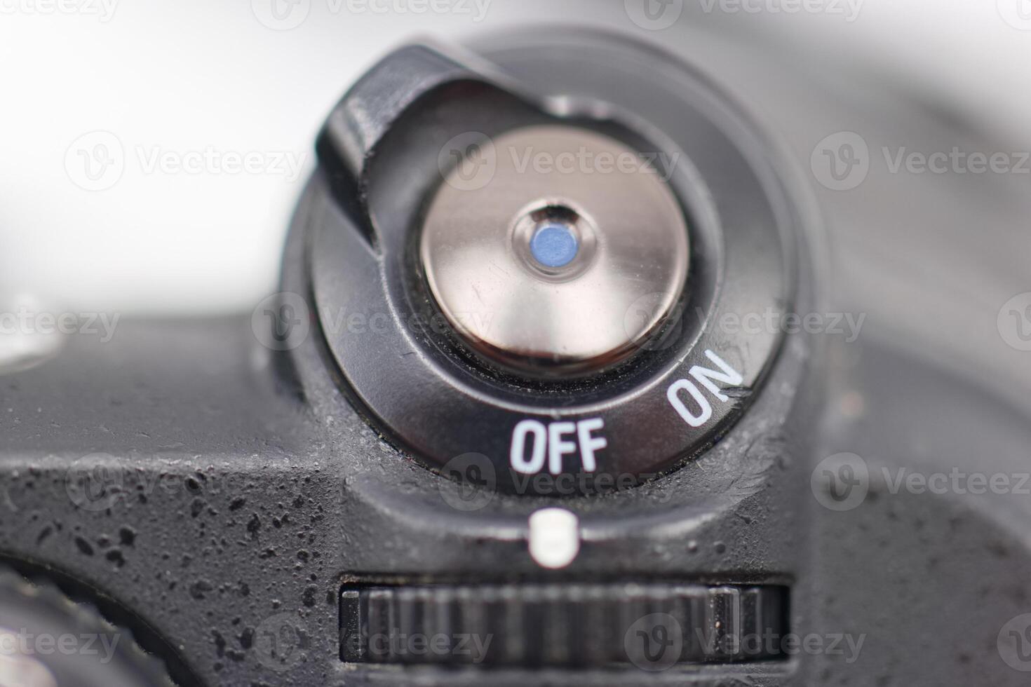 Camera power switch in close up showing off and on positions for photography equipment usage photo