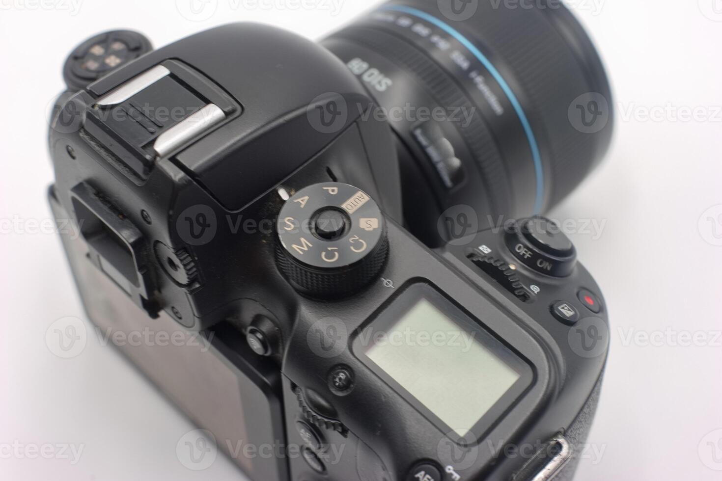 Detailed view of a professional camera featuring settings dial and lens highlighting photography equipment photo