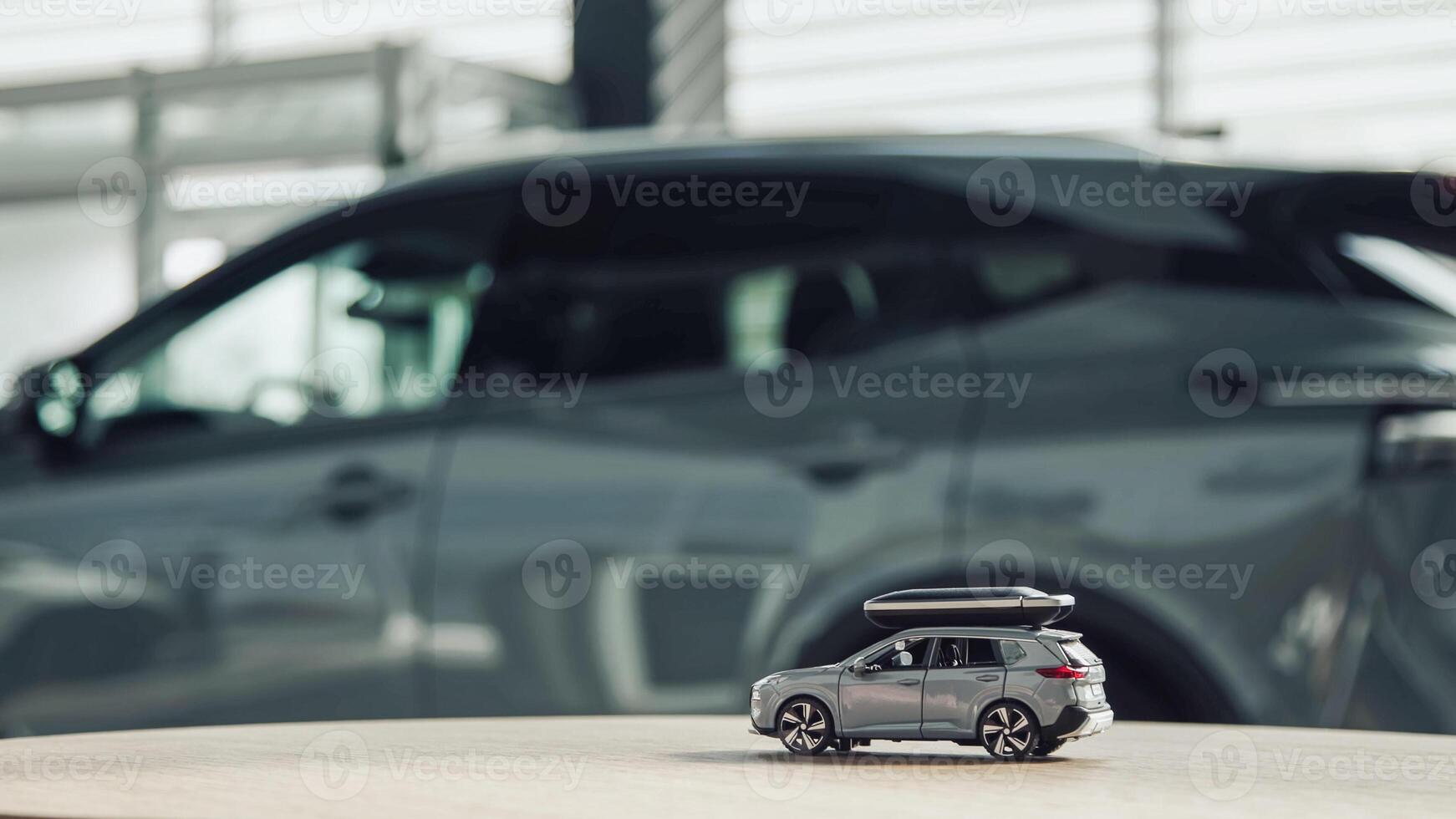 Toy car on the table in the car showroom of the dealership. Concept of buying, leasing, insurance. photo
