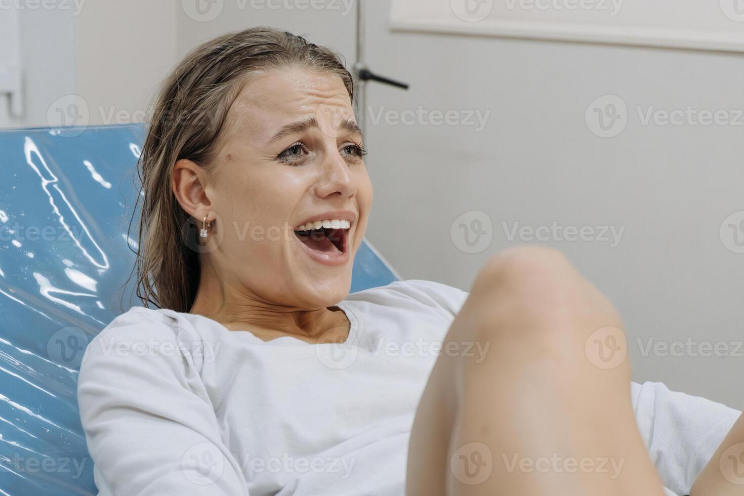 Women in labor, showing tension and emotion. Concept of the power of motherhood photo