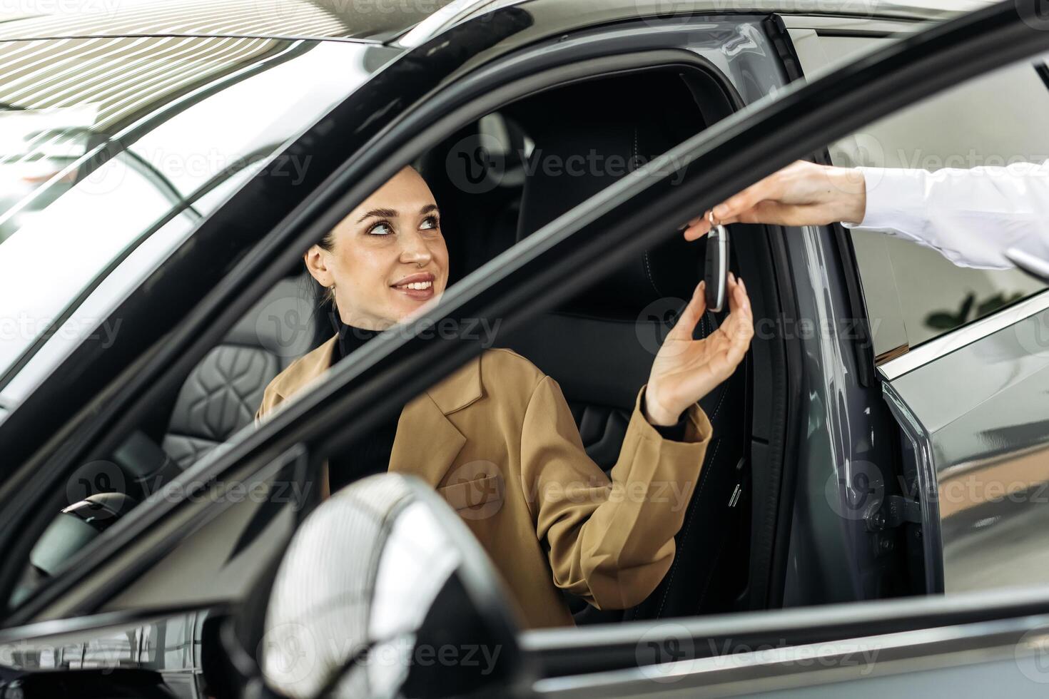 The completion of a car purchase or rental deal, with the handover of keys. Concept the final step of a seamless car buying, selling, or test-driving experience, highlighting customer satisfaction. photo