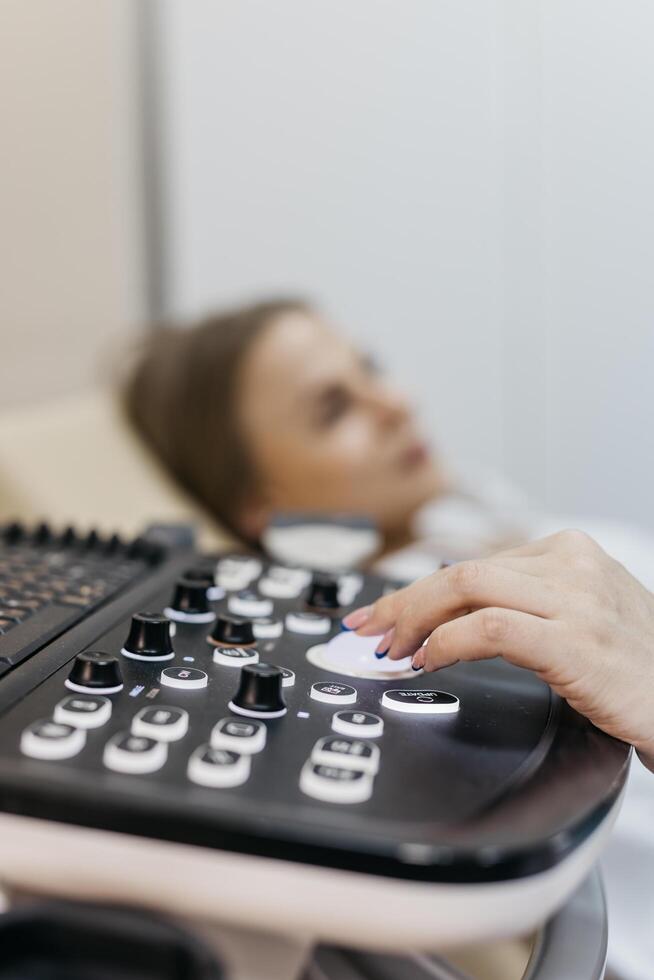 Concept medical imaging and diagnostic technology. Close-up of ultrasound machine as medical worker performs scan. photo