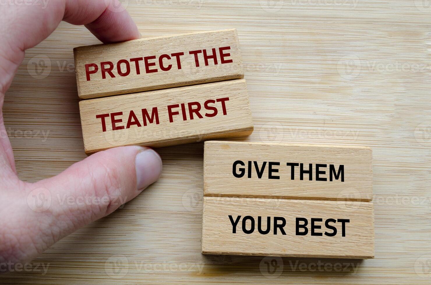 Protect the team first and give them your best text on wooden blocks, reinforcing the idea that effective leadership involves serving and uplifting others consistently photo