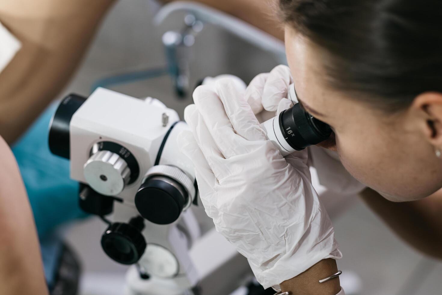 Gynecologist performs colposcopic examination. Concept of detailed medical examination. photo
