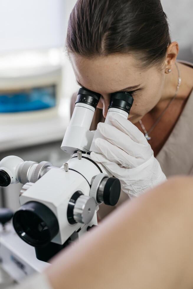 Gynecologist uses colposcope to examine cervix. Concept of women's health. photo