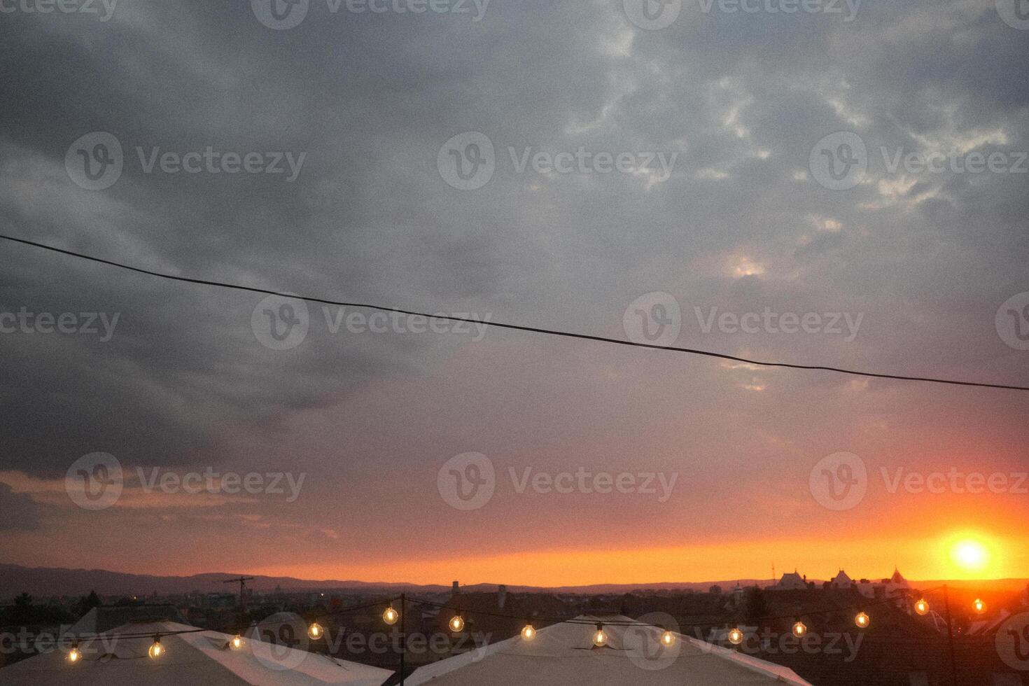 A blurry picture of a beautiful sunset with umbrellas in front photo