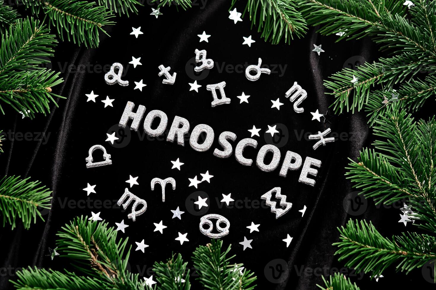 Abstract New Year background with the inscription Horoscope on a black velvet background. photo