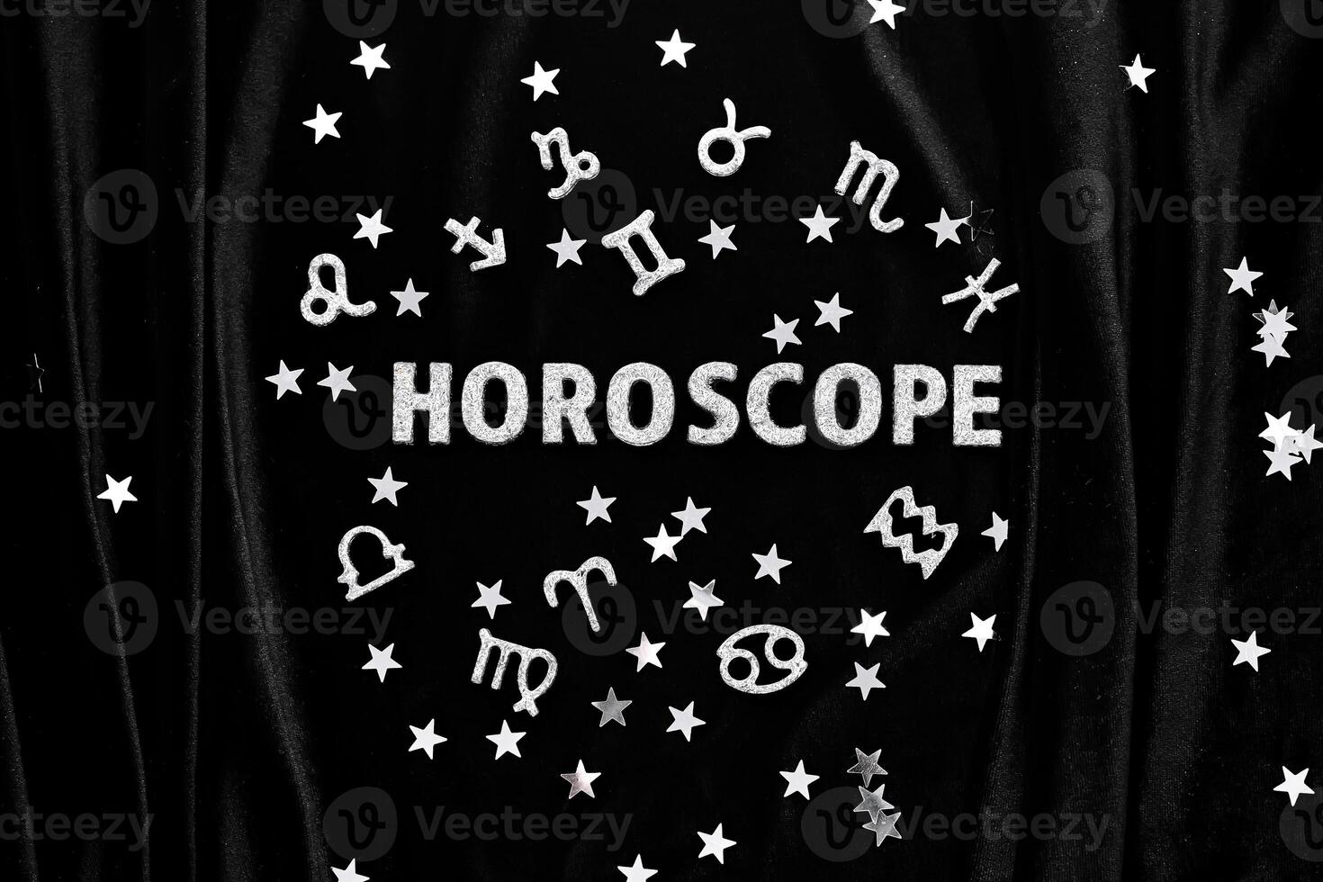 Abstract background with the inscription Horoscope on a black velvet background. photo