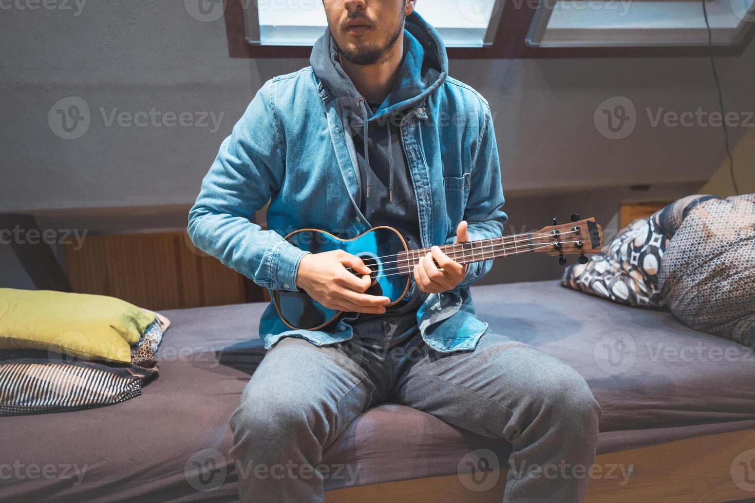 Musician mutes strings with his thumb to create rhythmic effects. photo