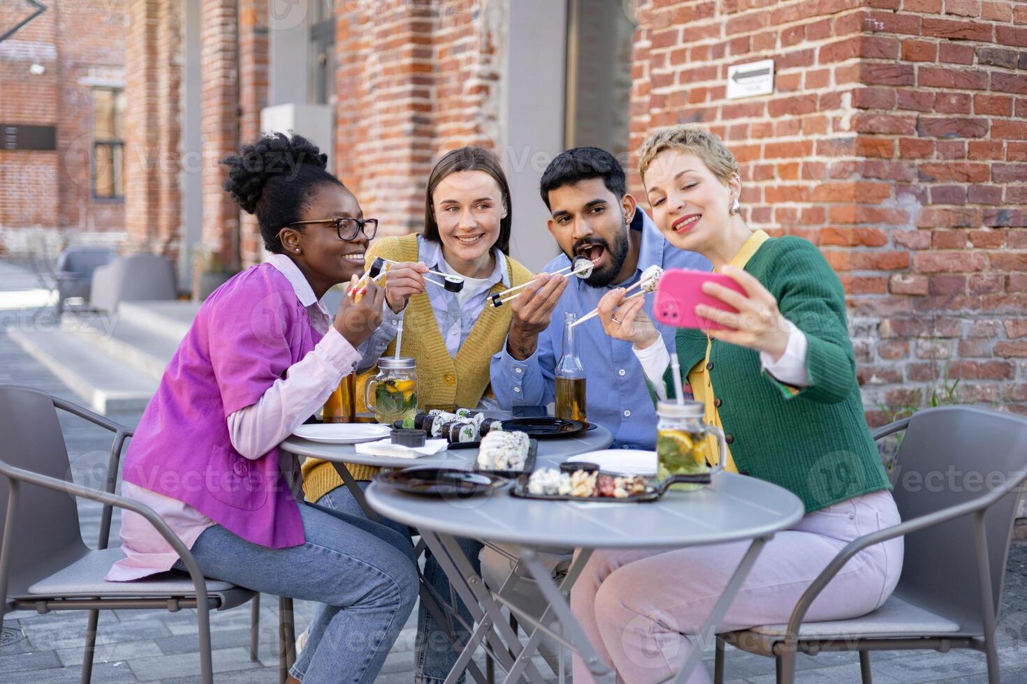 Group of friends eating sushi together photo