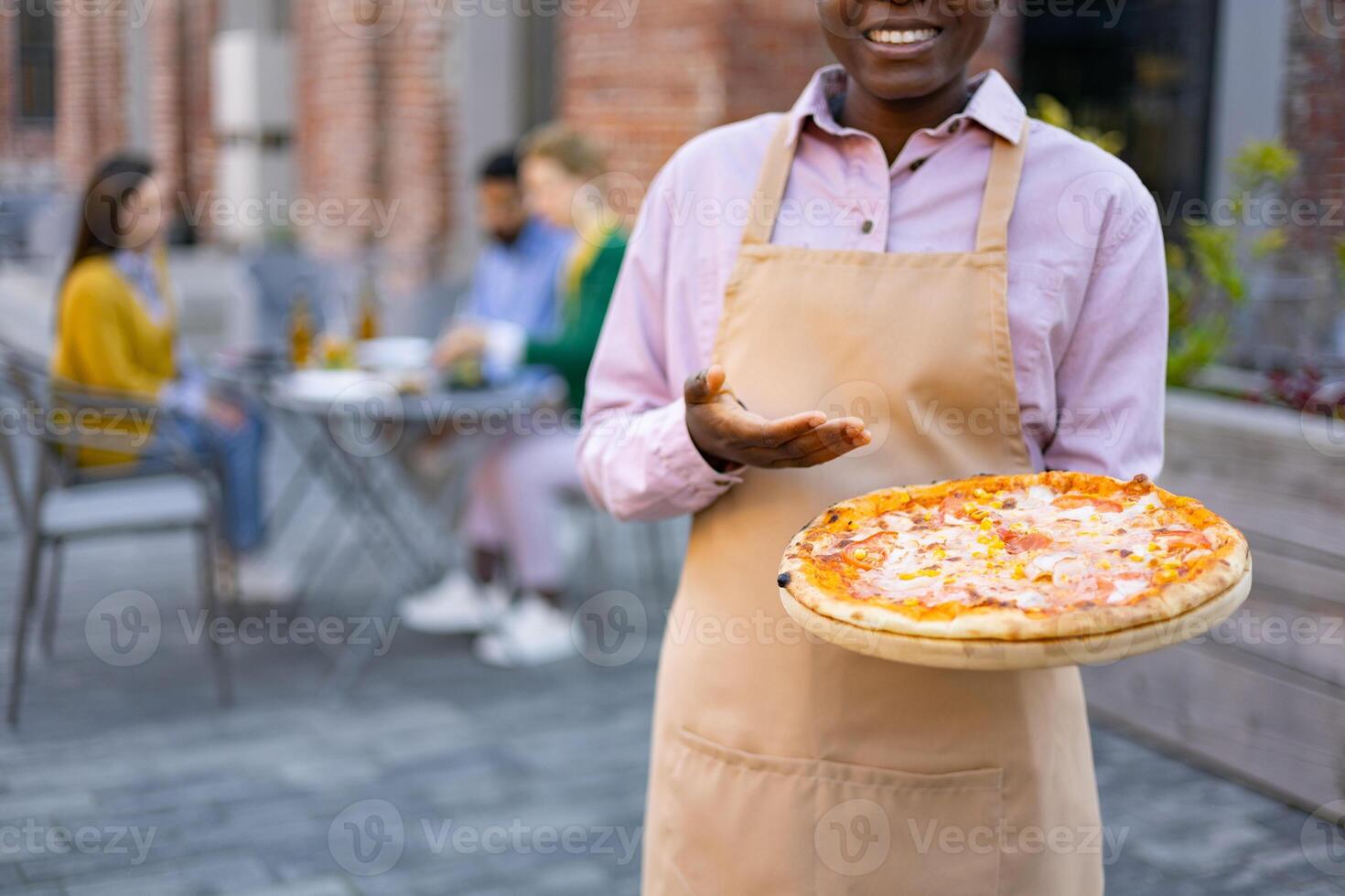 Pizza served by a smiling server photo