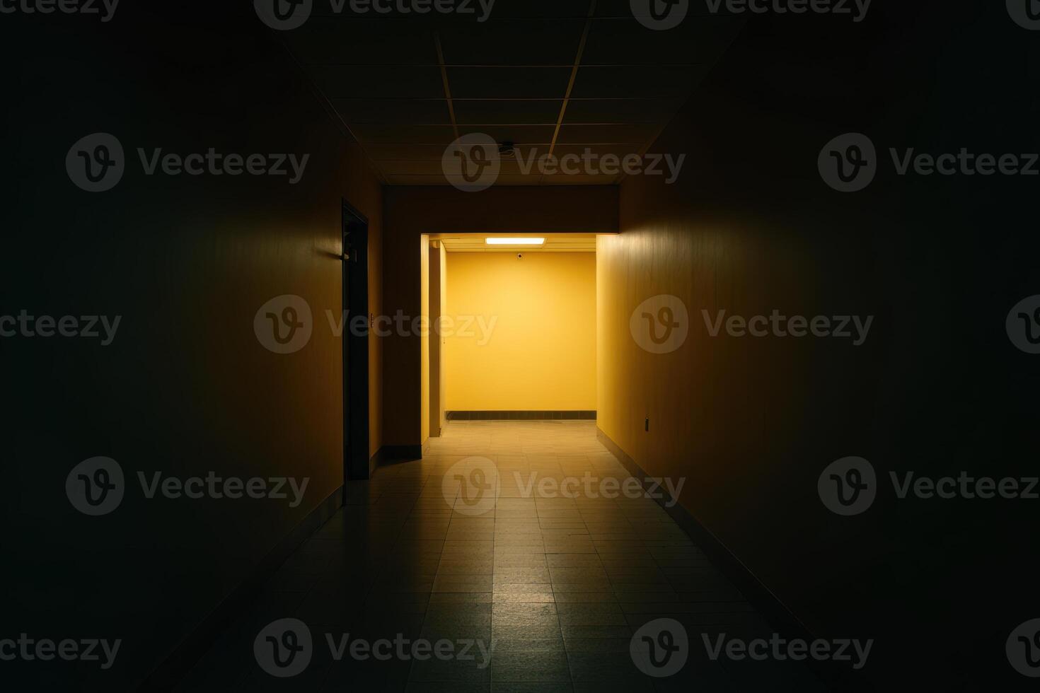 Darkened hallway leads to bright yellow room inside of an unknown Building, an ominous look into the unknown photo