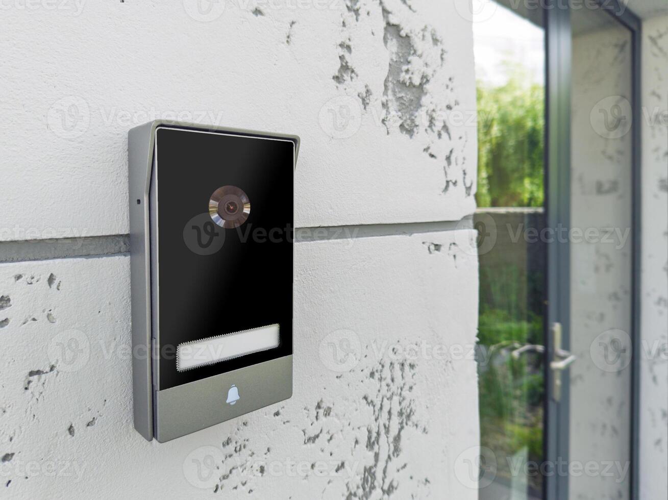 Smart doorbell with camera on modern wall photo