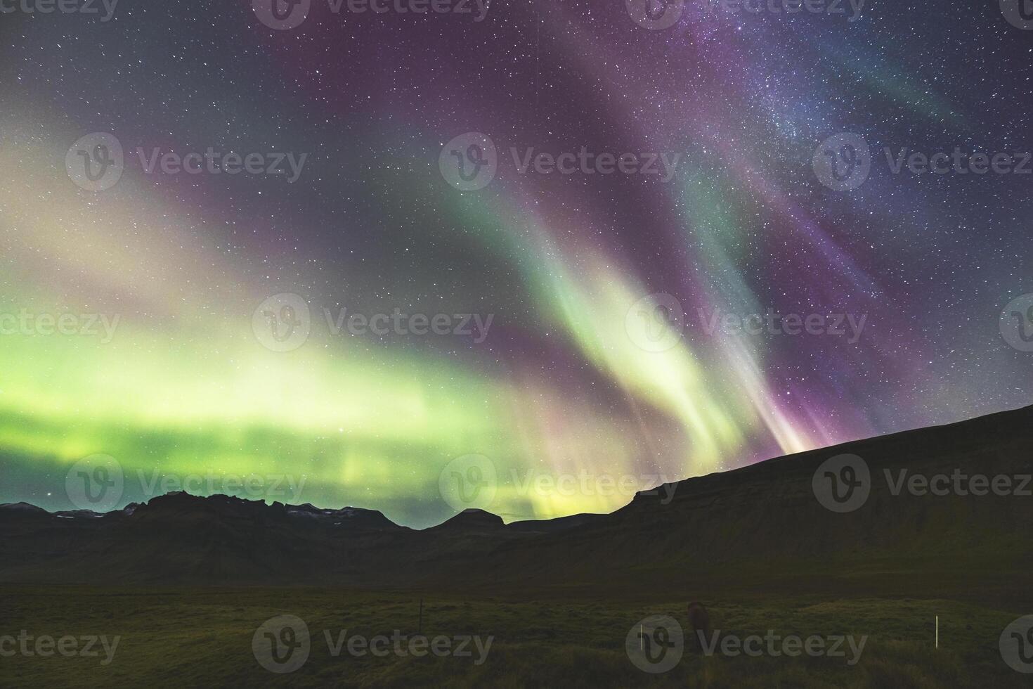 Emerald waves swirl above towering summits. photo