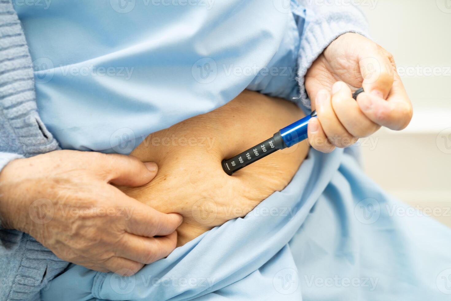 Senior woman patient injecting insulin diabetes. photo