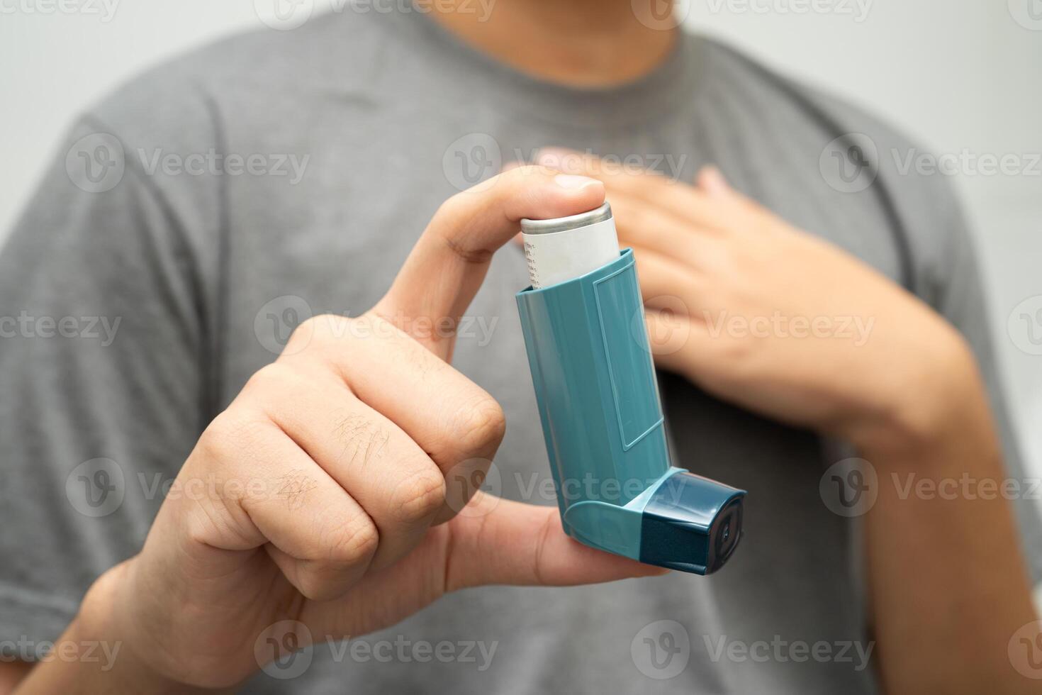 Asthma chronic obstructive pulmonary disease COPD, Asian young man using metered dose photo