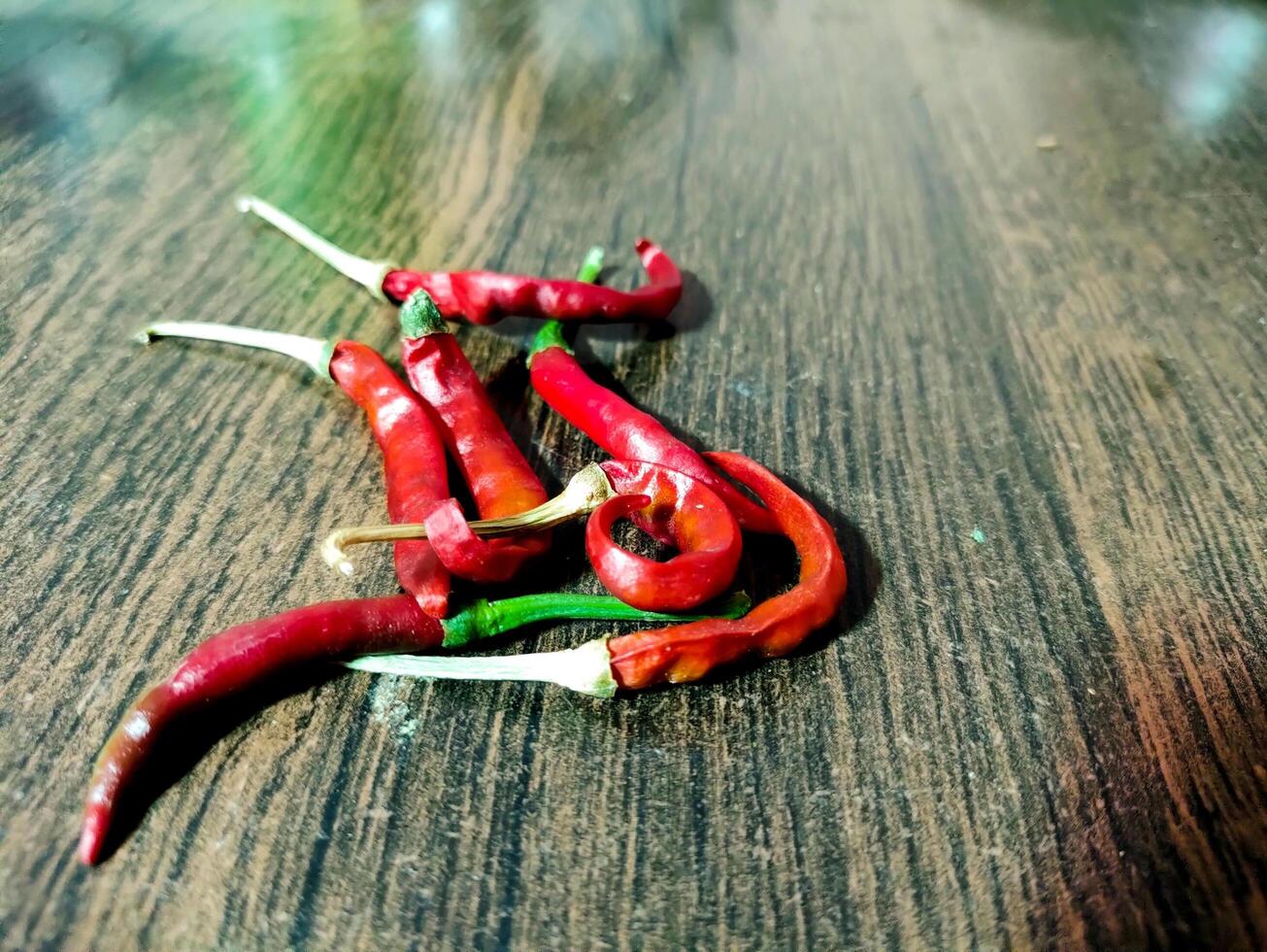 Dried Red Chilies on Wooden Surface photo