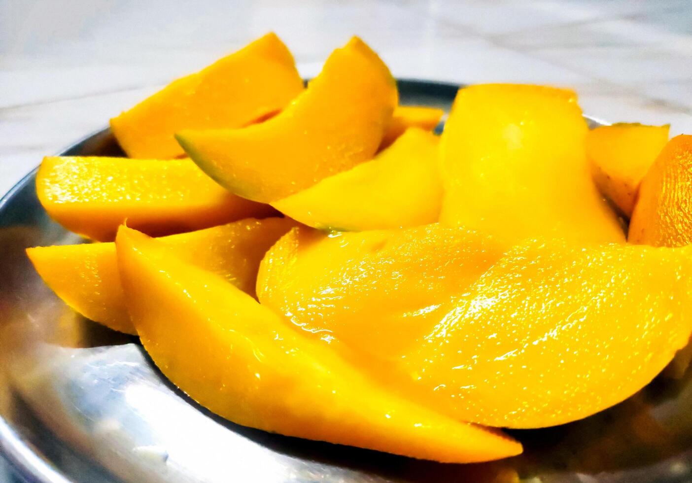 Sliced Ripe Mango in Steel Plate photo