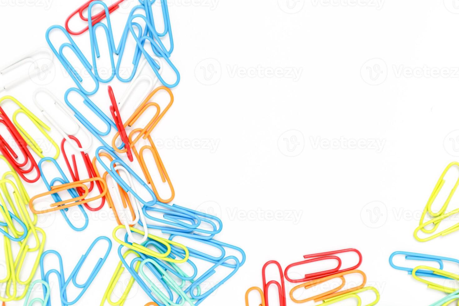 Colorful Paper Clips Scattered on a White Background Creating a Vibrant Visual photo