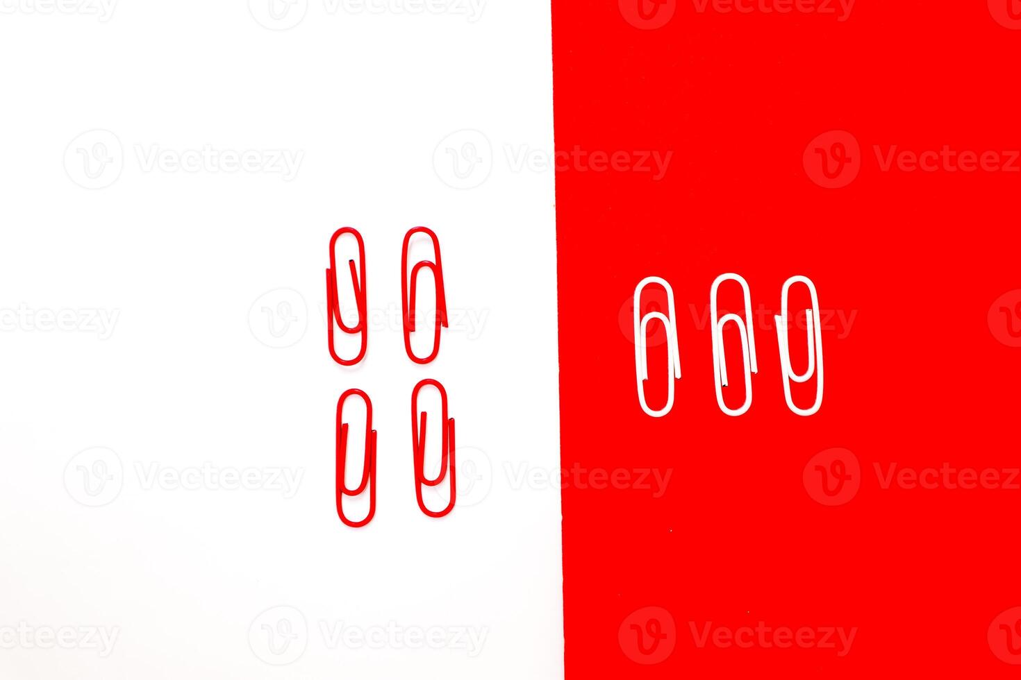 Paper clips in contrasting colors against a vibrant two-tone background create a striking visual effect photo