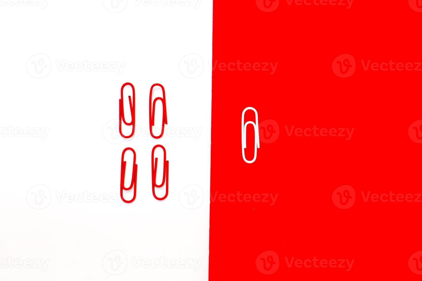 Minimalist composition of red and white paper clips on contrasting backgrounds photo