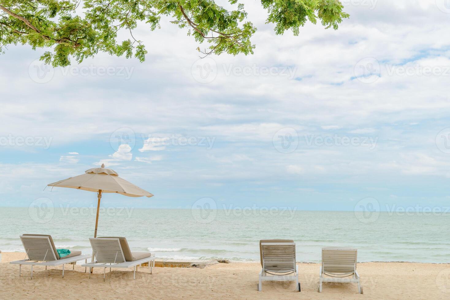 empty beach chairs on a beautiful beach at sunny day. vacation in summer time. photo