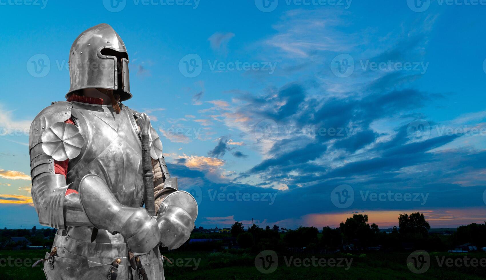 Knight in helmet and metal armor. Protecting your safety. photo