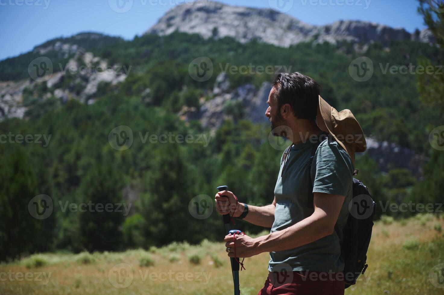 Hiker Exploring Nature in a Scenic Mountain Landscape with Trekking Gear photo