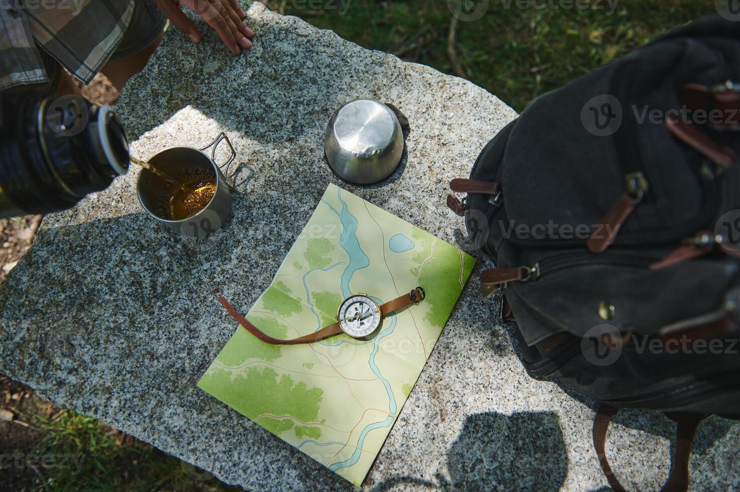 Exploration Essentials on Granite Surface Featuring Map, Compass, and Hiking Gear photo