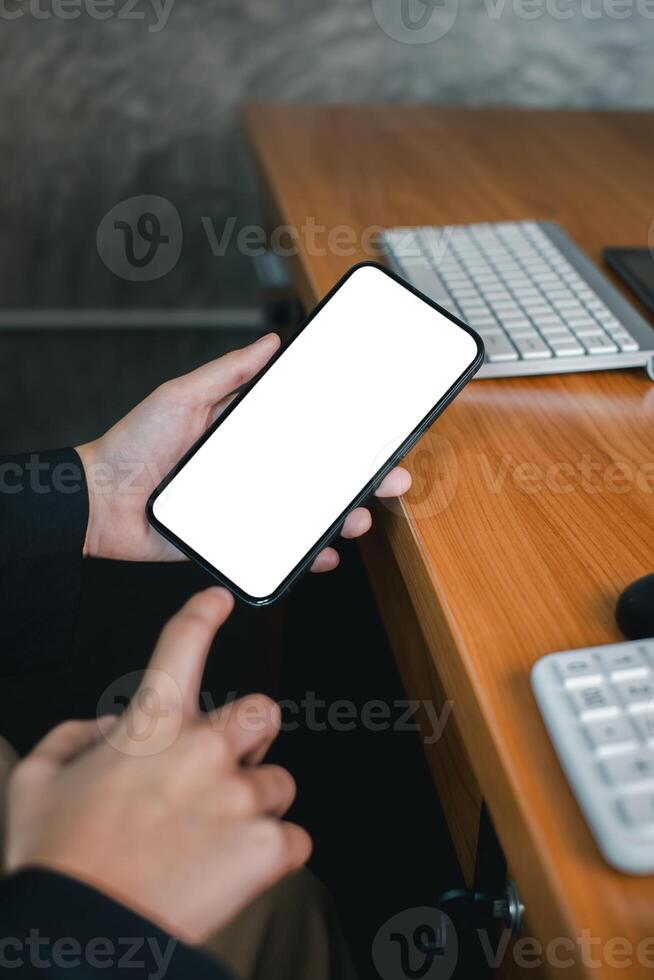 Close-up of a person holding a smartphone with a blank screen, ideal for mockups or design presentations. photo