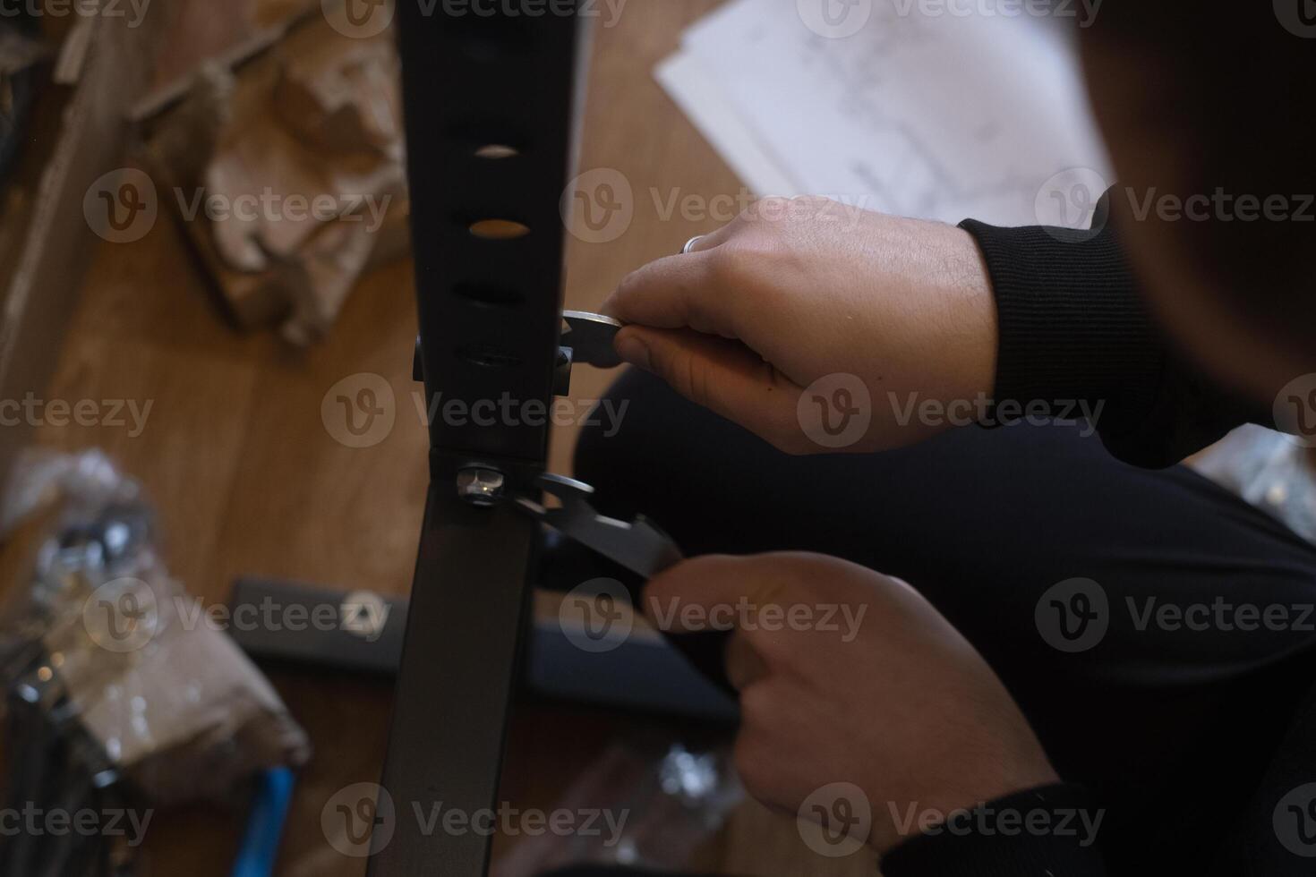 Man assembling fitness equipment at home preparing a gym for daily exercise and healthy lifestyle routines. photo