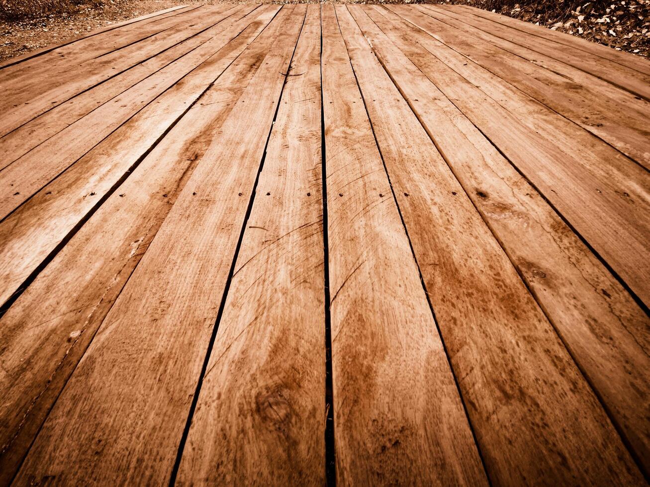 Weathered wooden planks laid parallel on a pathway textured surface with visible grain photo
