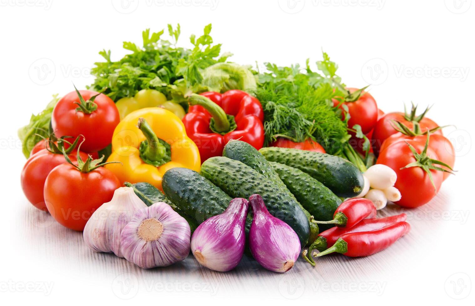 Variety of fresh organic vegetables isolated on white photo