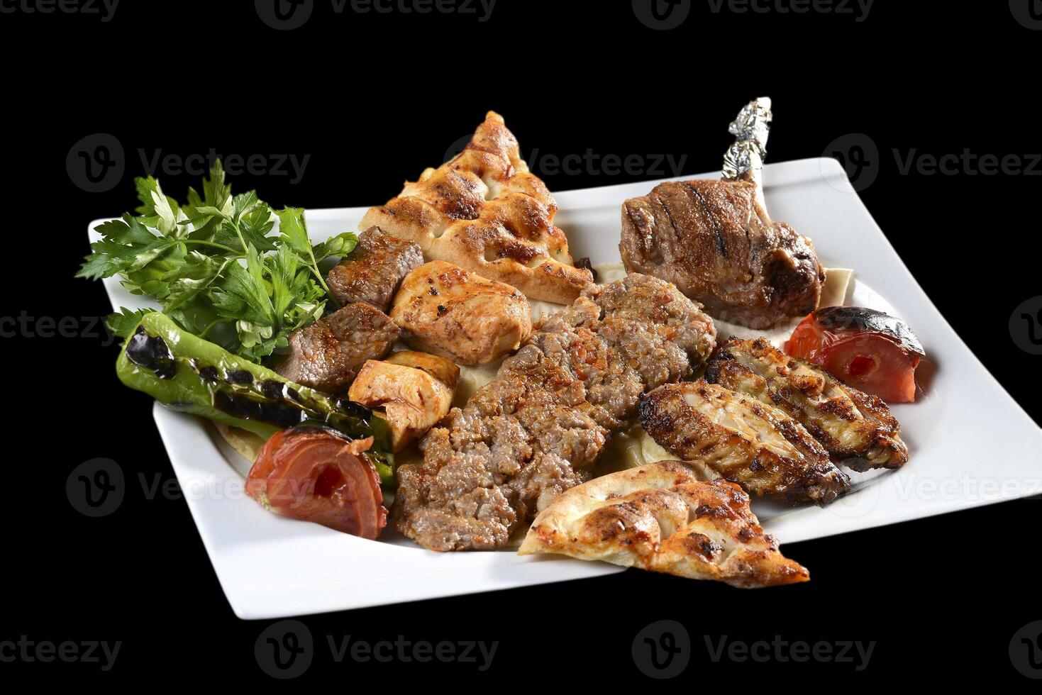A plate of food with meat, vegetables and bread photo