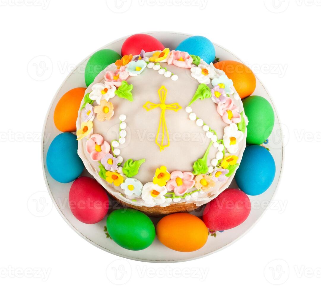Painted Easter eggs and delicious cupcake on white isolated background photo
