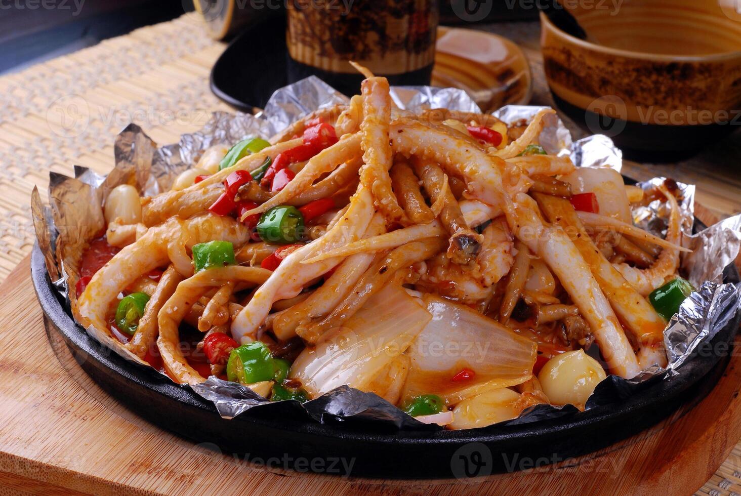 Sautéed chicken feet with vegetables photo