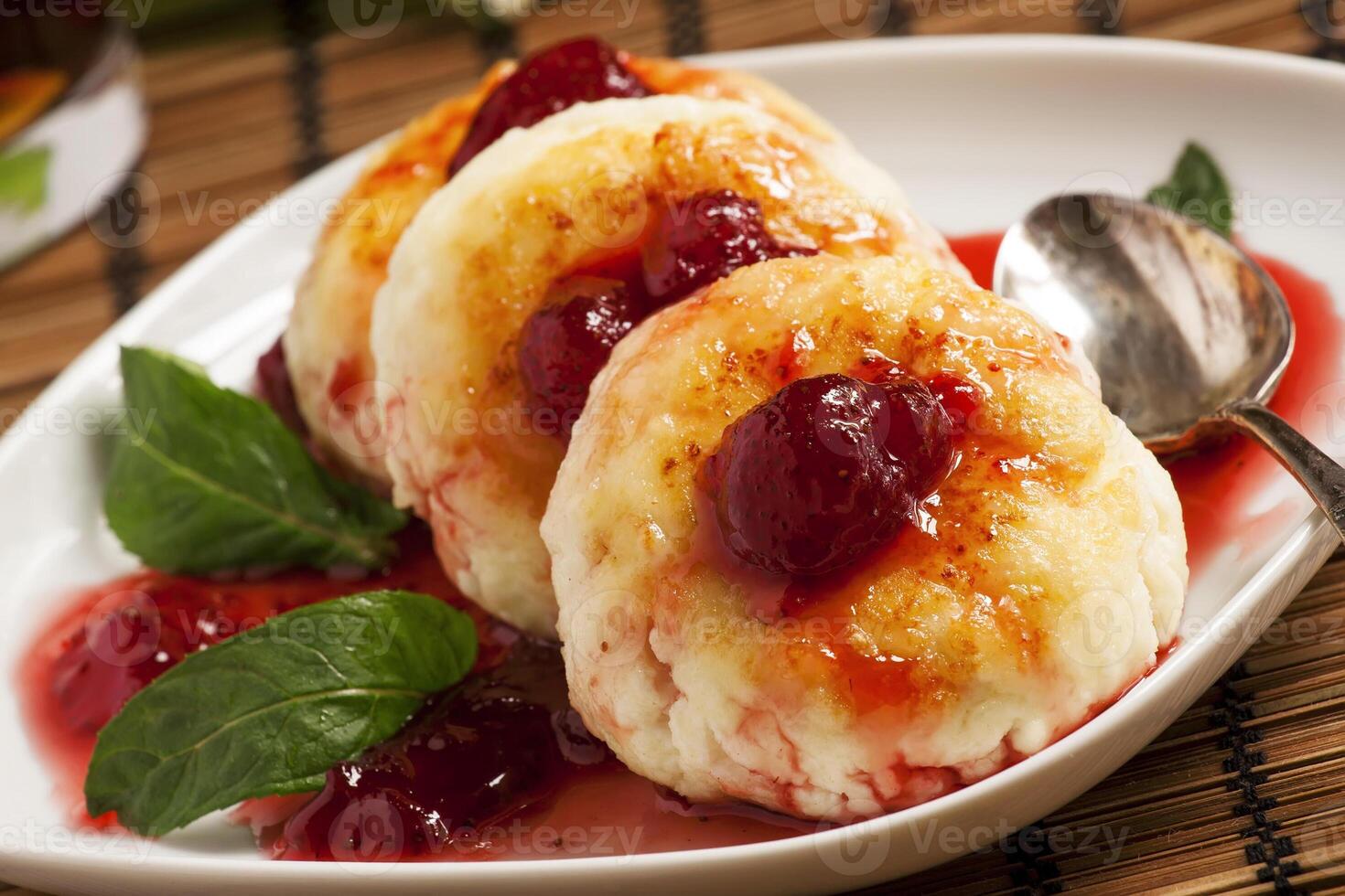 Homemade cottage cheese pancakes with strawberry jam, selective photo